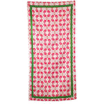 Patterned fabric with pink and green design on a white background