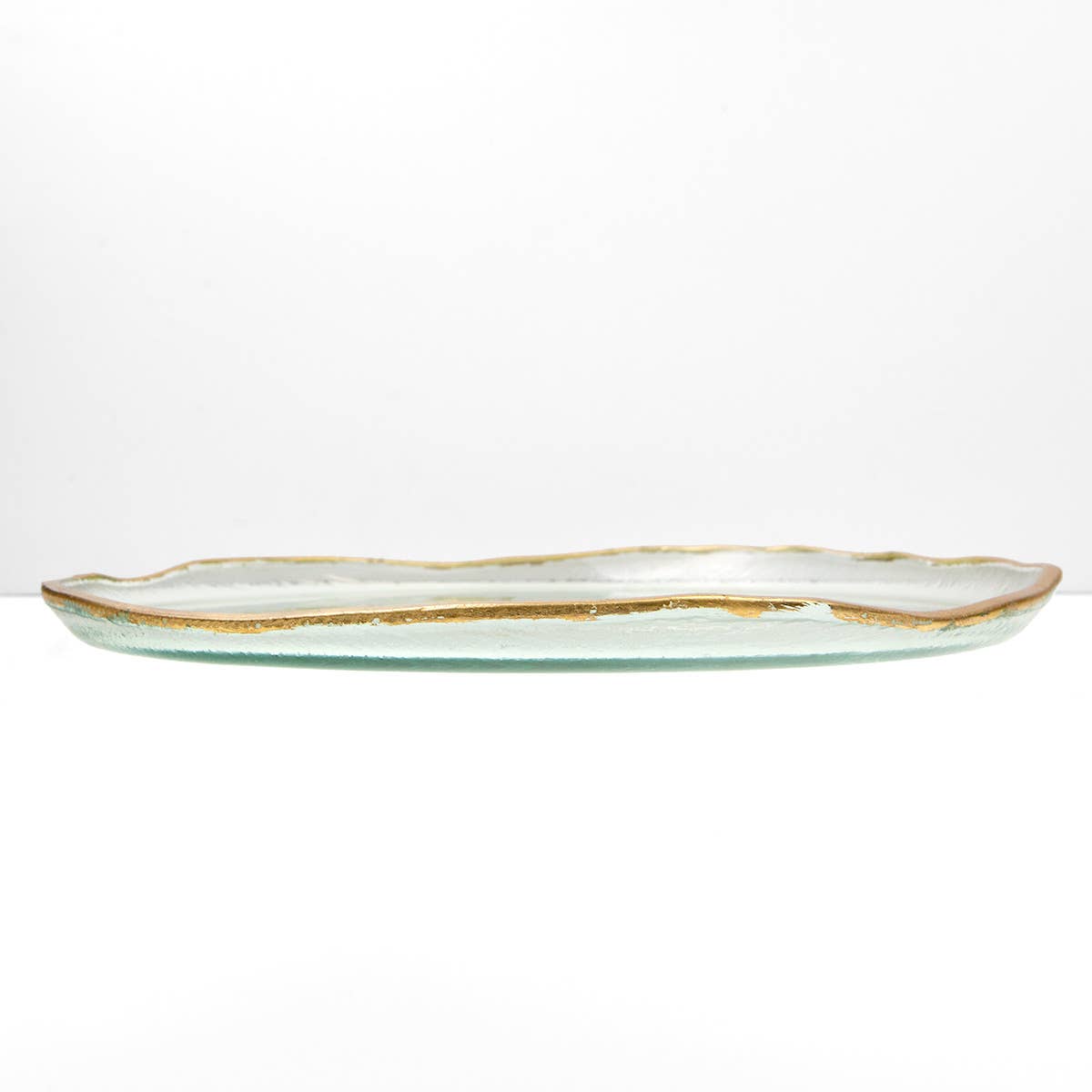 Glass tray with gold rim on a white background